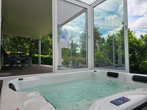 a bath tub with a large window in a house at Quinta Lama de Cima in Fafe
