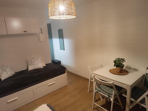 a room with a bed and a table with a potted plant at Le petit Miraline in Villarembert