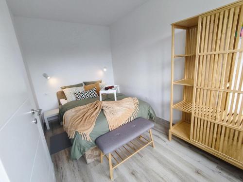 a small bedroom with a bed and a chair at Apartman Serbus-Zagreb in Zagreb