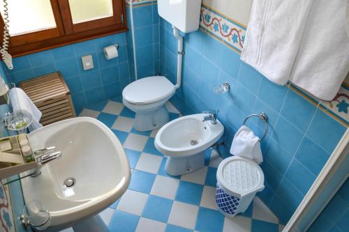 a bathroom with a toilet, sink, and tub at Hotel Locanda Ruscello Garnì in Limone sul Garda