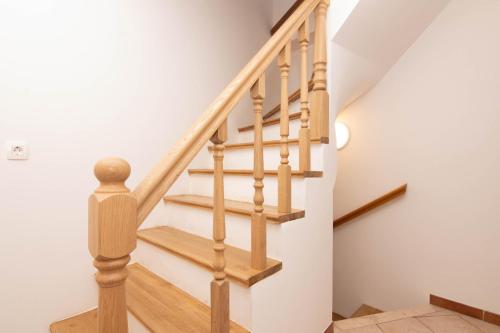 a staircase with wooden railings in a house at Apartments Leonel by Locap Group in Piran