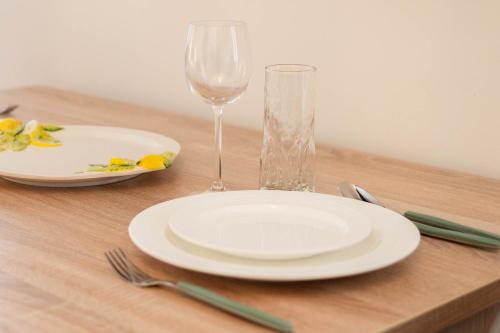 a table with a white plate and a wine glass at Apartments Leonel by Locap Group in Piran