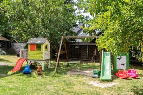 a group of childrens playground equipment in a yard at Apartamenty w Dworku Cheval in Kraków