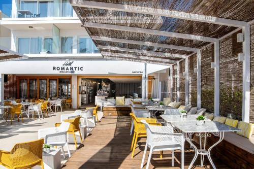 an outdoor patio with tables and chairs and a restaurant at Cabot Romantic- Adults Only in Port de Pollensa