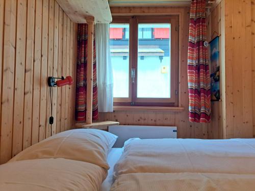 a bedroom with a bed and a window at Casetta di Carì by Quokka 360 - spacious family flat in Cala