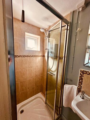 a bathroom with a shower and a sink at Coastal Charm in Donegal