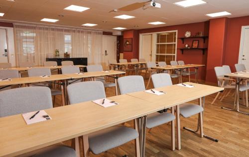 a conference room with tables and chairs with napkins at Quality Hotel Grand Falun in Falun