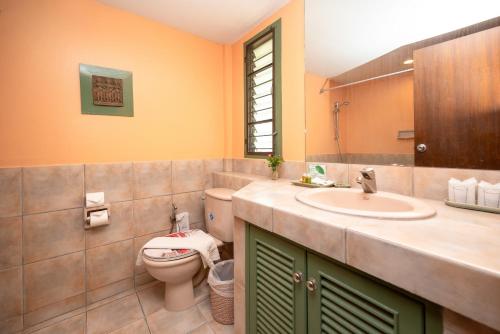 a bathroom with a toilet and a sink at Comsaed River Kwai Resort in Kanchanaburi