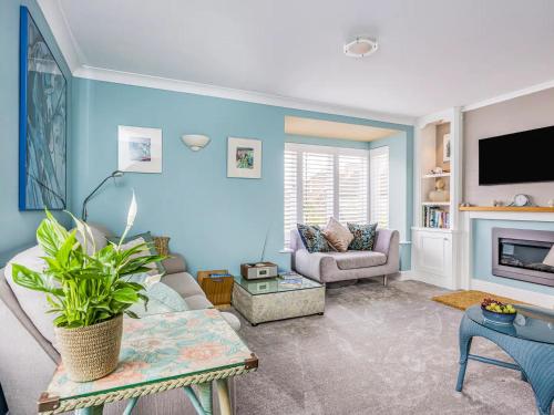 a living room with a couch and a tv at City Centre Town House w Parking - Pass the Keys in Chichester