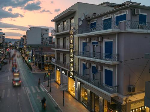 a building with a hotel sign on the side of it at H&ocirc;tel Argo in Volos