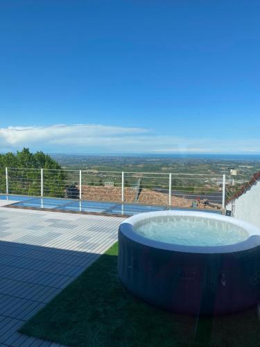 a hot tub on top of a patio with a view at San Marino Skyline - Suite Olimpio in San Marino