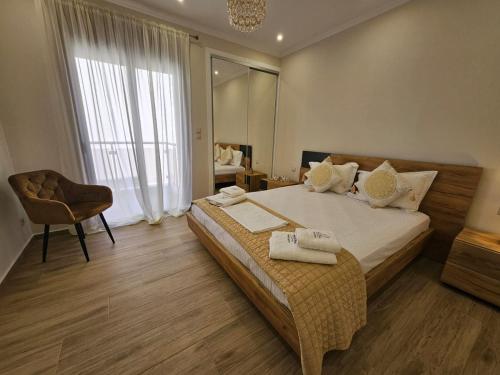 a bedroom with a large bed with towels on it at Agora Luxury Villa I in Loutraki