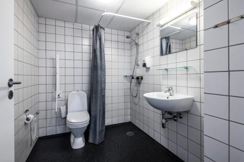 a bathroom with a toilet and a sink at HOTEL SØMA Ilulissat in Ilulissat