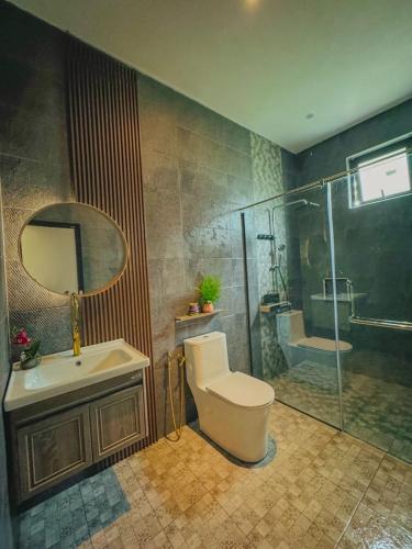 a bathroom with a toilet and a sink and a shower at Mawarvilla jb in Johor Bahru
