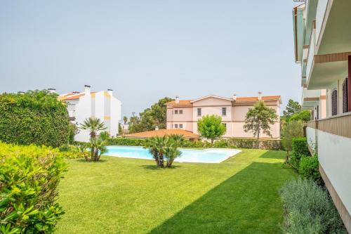 an image of a backyard with a swimming pool at GuestReady - Coastal Bliss in Praia de Troia in Troia