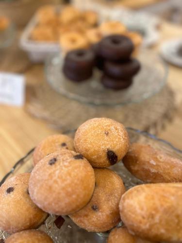 a pile of donuts on a glass plate on a table at Hotel Villa Frigiliana in Frigiliana