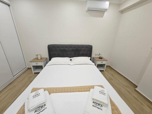 a bedroom with a large bed with two night stands at Agora Luxury Villa I in Loutraki