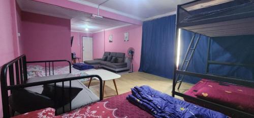 a room with two bunk beds and a couch at Kupi-Kupi & Stay in Kundasang