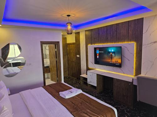 a hotel room with a tv on a wall at Presken Kuramo Waters in Lagos