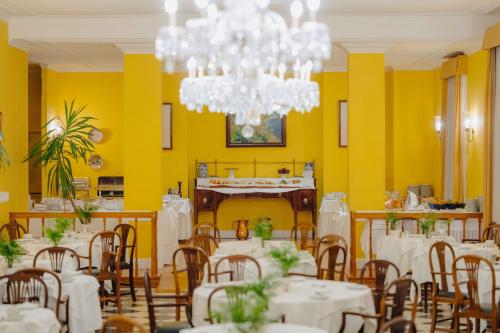 a dining room with tables and chairs and a chandelier at Quinta da Bela Vista in Funchal