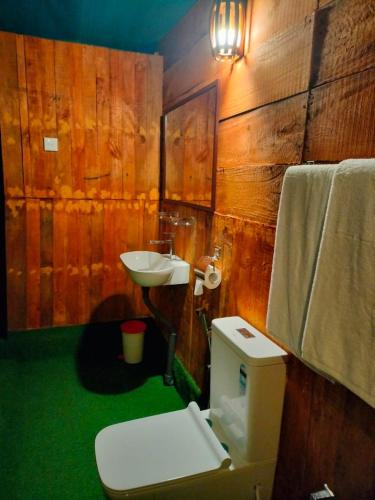 a bathroom with a toilet and a sink at Harmony Haven, Udawalawe, Sri Lanka in Udawalawe