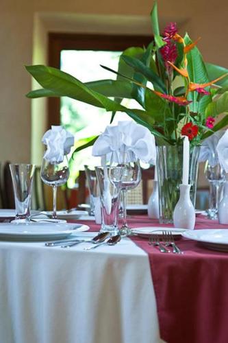 a table with a vase of flowers on a table at Hacienda Chichen Resort and Yaxkin Spa in Chichén-Itzá
