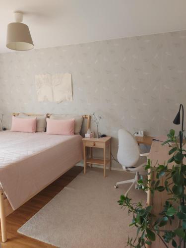 a bedroom with a bed and a desk and a chair at feel like your own home in Linköping