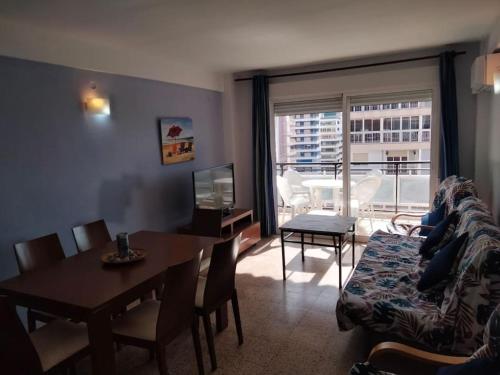 un soggiorno con divano e tavolo e una sala da pranzo di Acogedor Apartamento Cullera 200 metros playa a Cullera