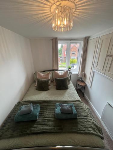 a bedroom with a large bed with two pillows at The Annex in York in York