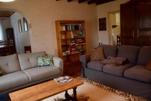 a living room with two couches and a coffee table at Maison au coeur du vignoble in Libourne