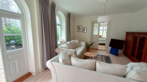 a living room with white couches and a window at Apartment in Danmark -Petersminde Exclusive Apartments in Otterup