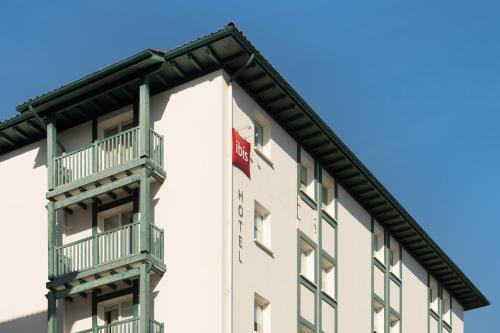 a building with balconies on the side of it at ibis Ciboure Saint-Jean-de-Luz in Ciboure