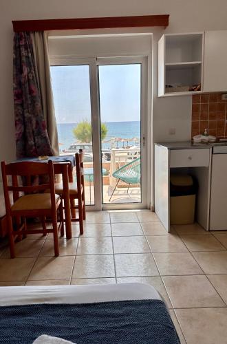 a kitchen and dining room with a view of the ocean at Stegna Sea & Sun in Archangelos