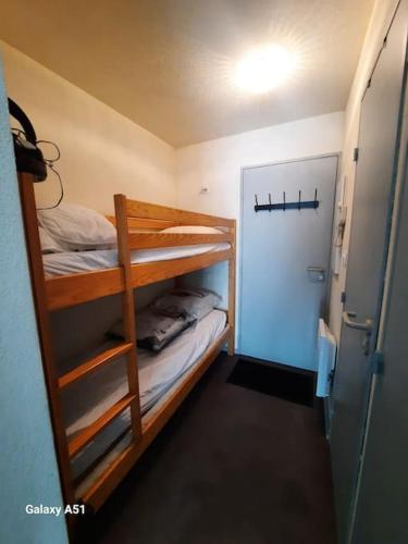 Cette petite chambre comprend des lits superposés et une porte. dans l'établissement Studio 4 pers avec parking souterrain, à Cauterets