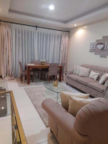 a living room with a couch and a table at Silverstone Apartments Nairobi, Kilimani in Nairobi