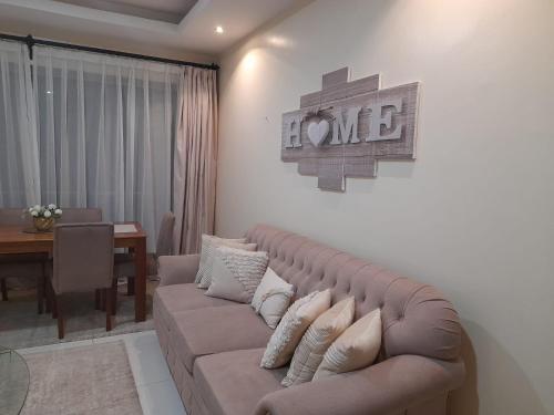 a living room with a couch and a dining table at Silverstone Apartments Nairobi, Kilimani in Nairobi