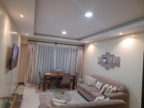 a living room with a couch and a table at Silverstone Apartments Nairobi, Kilimani in Nairobi