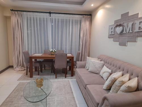 a living room with a couch and a table at Silverstone Apartments Nairobi, Kilimani in Nairobi