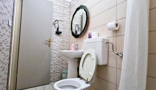 a small bathroom with a toilet and a mirror at 3 Mini Studios in Siniscola in Siniscola