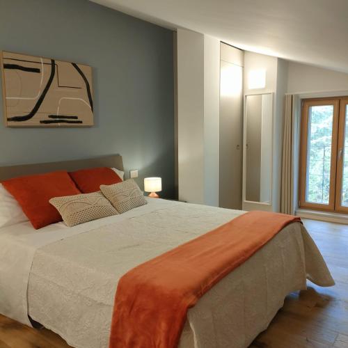 a bedroom with a large bed with an orange blanket at Villa dei tigli - Altamura in Altamura