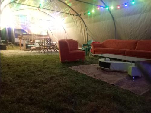 un canapé et une table dans une tente dans l'établissement Bivouac, à Le Fay