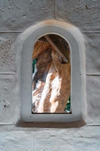 a window in a stone wall in a building at La Santa Rosa in Uluwatu