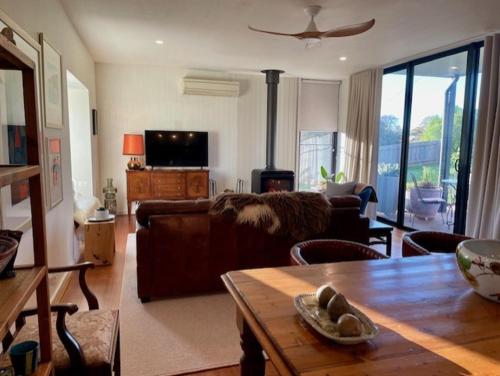 a living room with a couch and a table at The Mod Clunes in Clunes