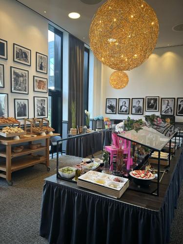 a buffet of food on a table in a room at Airport Plaza Hotel Hamburg in Norderstedt