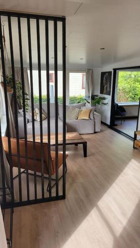a living room with a couch and a table at Family vibes, op 5 sterren vakantiepark in Limburg in Sevenum