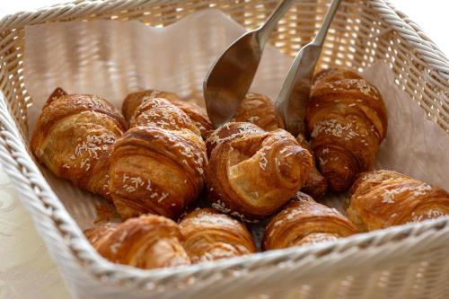 a basket full of pastries with two knives in it at Grand Hotel Mediterranee in Alassio