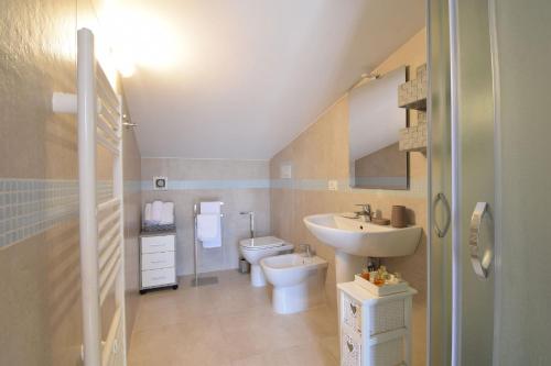 a bathroom with a sink and a toilet and a sink at Villa Eve In Molise With Private Pool in Guardialfiera