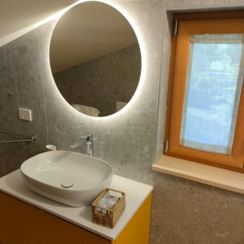 a bathroom with a white sink and a mirror at Villa dei tigli - Altamura in Altamura