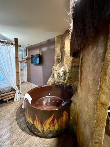 a bathroom with a large tub with a statue at Posada la Leyenda in Santillana del Mar