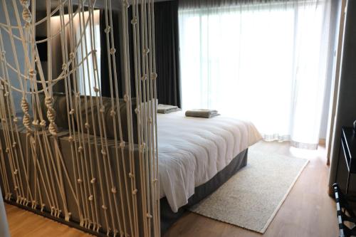 a bedroom with a bed with a white bedspread at Santa Cruz - Movement & Nature House in Santa Cruz